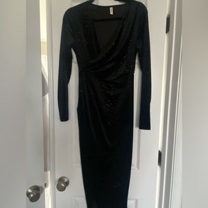 Black long sleeve mid length dress. Never worn; new.